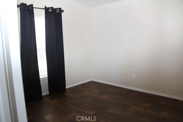 a view of a closet with wooden floor
