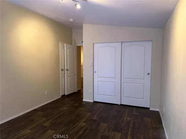an empty room with wooden floor