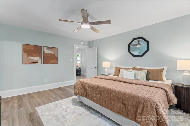 a bedroom with a bed and a chandelier