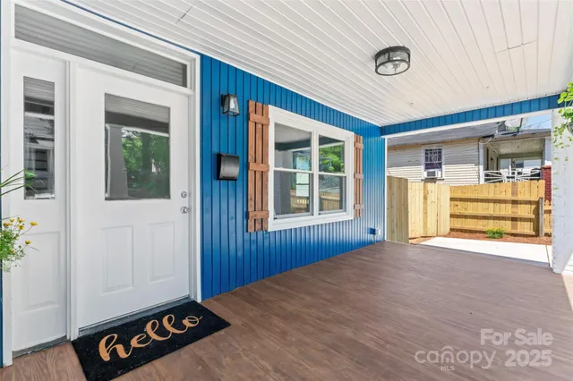 a view of a room with wooden floor and windows