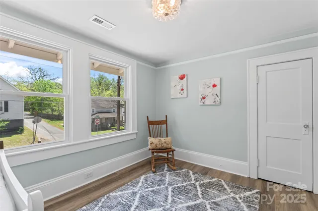 a living room with a window and a rug