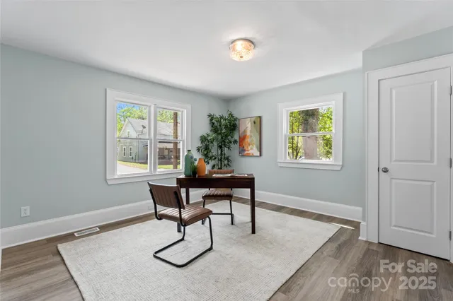a workspace with wooden floor and a window