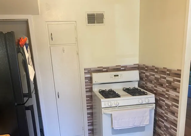 a view of a storage and utility room with washer and dryer