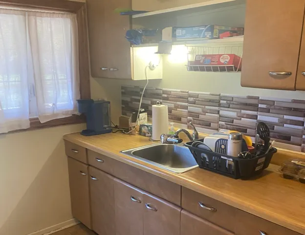 a kitchen with a sink and cabinets