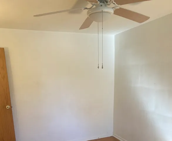 a bathroom with a fan and a shower