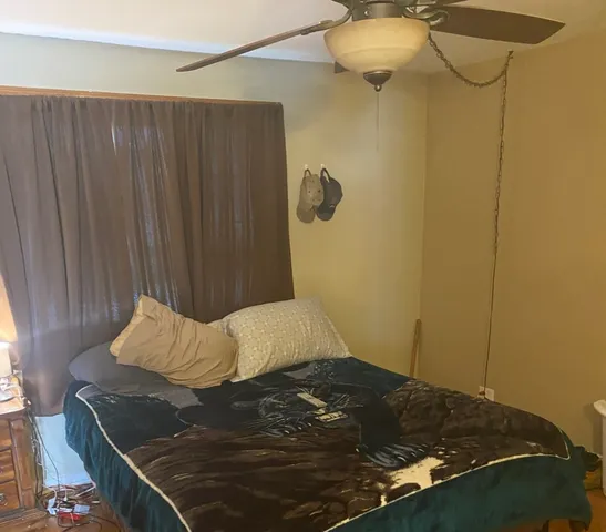 a bed sitting in a bedroom and chair