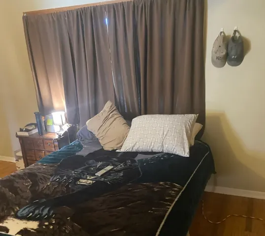 a bed sitting in a bedroom next to a window