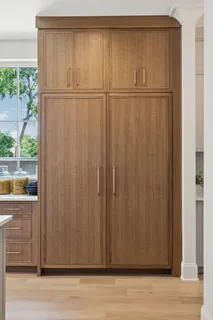 a kitchen with a stove and a white cabinet