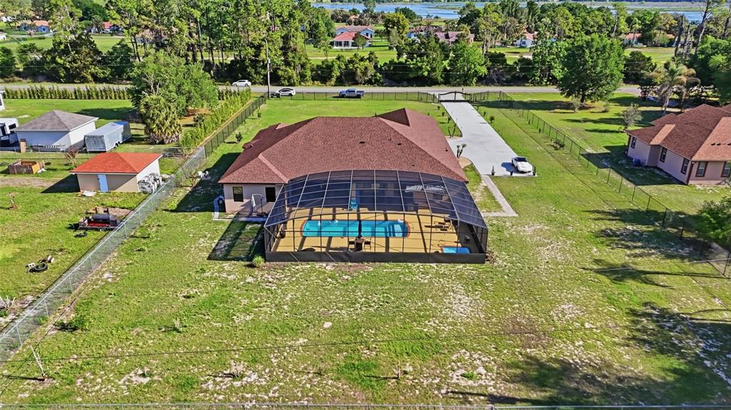 13429 Montevista Road Clermont, FL 34711 - Photo 4 of 89 a view of a swimming pool with a garden and trees