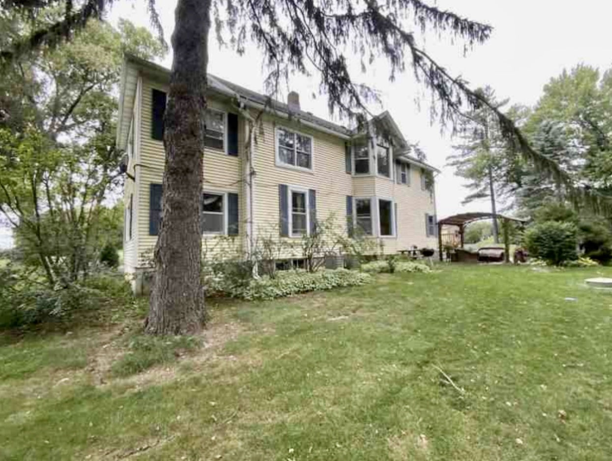 2302 Main Street Spring Grove, IL 60081 - Photo 2 of 2 a front view of a house with a garden