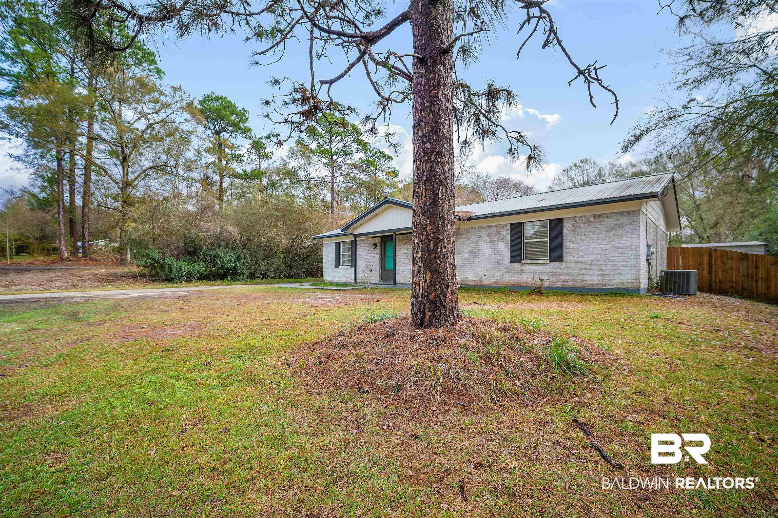 5110 Wilmer Road Wilmer, AL 36587 - Photo 2 of 24 Ranch-style home featuring central AC and a front lawn