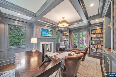 a living room with furniture a fireplace and a floor to ceiling window