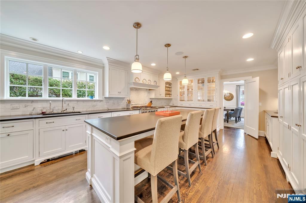 227 Fairmount Road Ridgewood, NJ 07450 - Photo 16 of 50 a kitchen with a table chairs refrigerator and window