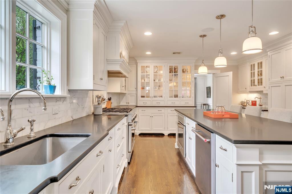 227 Fairmount Road Ridgewood, NJ 07450 - Photo 17 of 50 a kitchen with a sink stove and cabinets