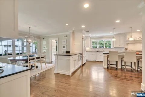 a kitchen with stainless steel appliances granite countertop a sink and stove