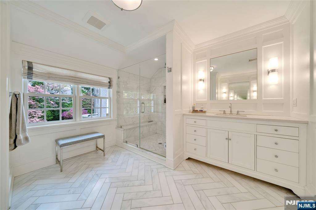 227 Fairmount Road Ridgewood, NJ 07450 - Photo 32 of 50 a spacious bathroom with a double vanity sink a large mirror and a bathtub