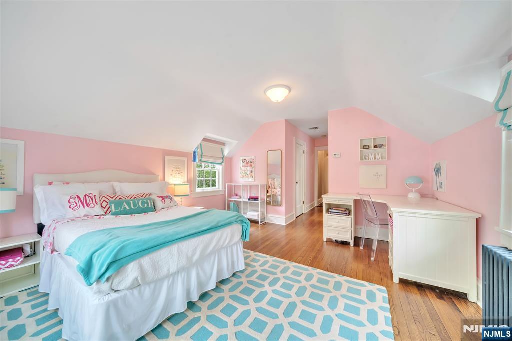227 Fairmount Road Ridgewood, NJ 07450 - Photo 34 of 50 a bedroom with a bed and wooden floor
