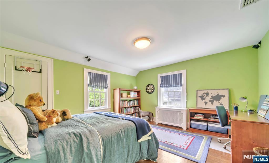 227 Fairmount Road Ridgewood, NJ 07450 - Photo 37 of 50 a bedroom with a bed and wooden floor