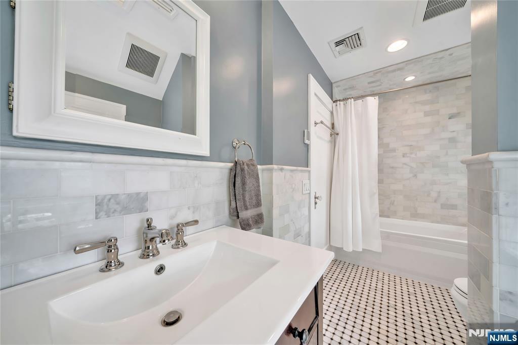 227 Fairmount Road Ridgewood, NJ 07450 - Photo 39 of 50 a bathroom with a sink a toilet a shower and a mirror