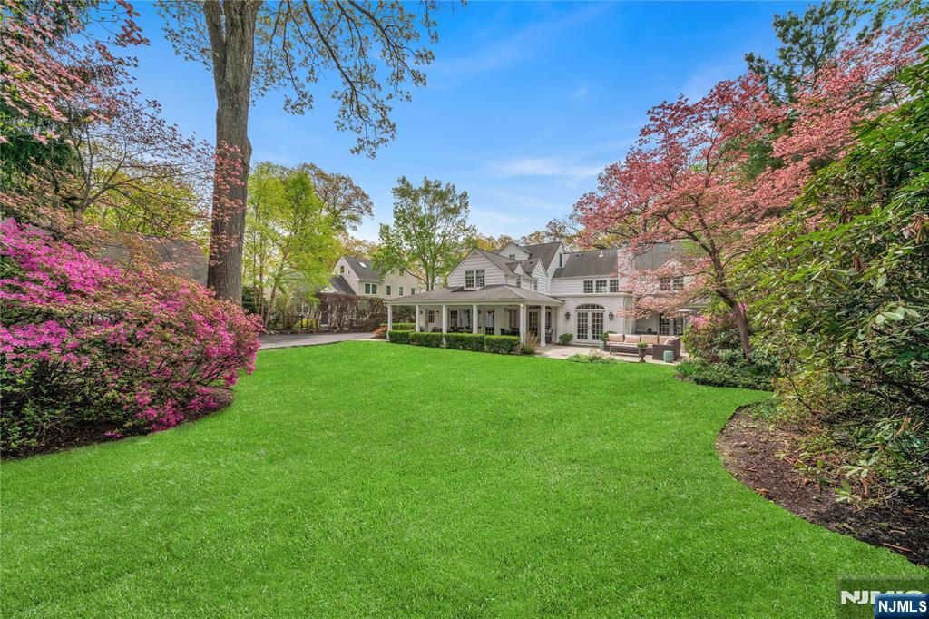227 Fairmount Road Ridgewood, NJ 07450 - Photo 47 of 50 a view of a house with garden and a bench