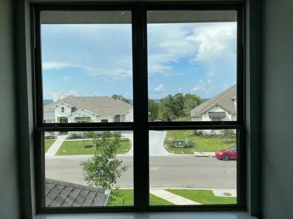 a view of a glass door with a tree from a window