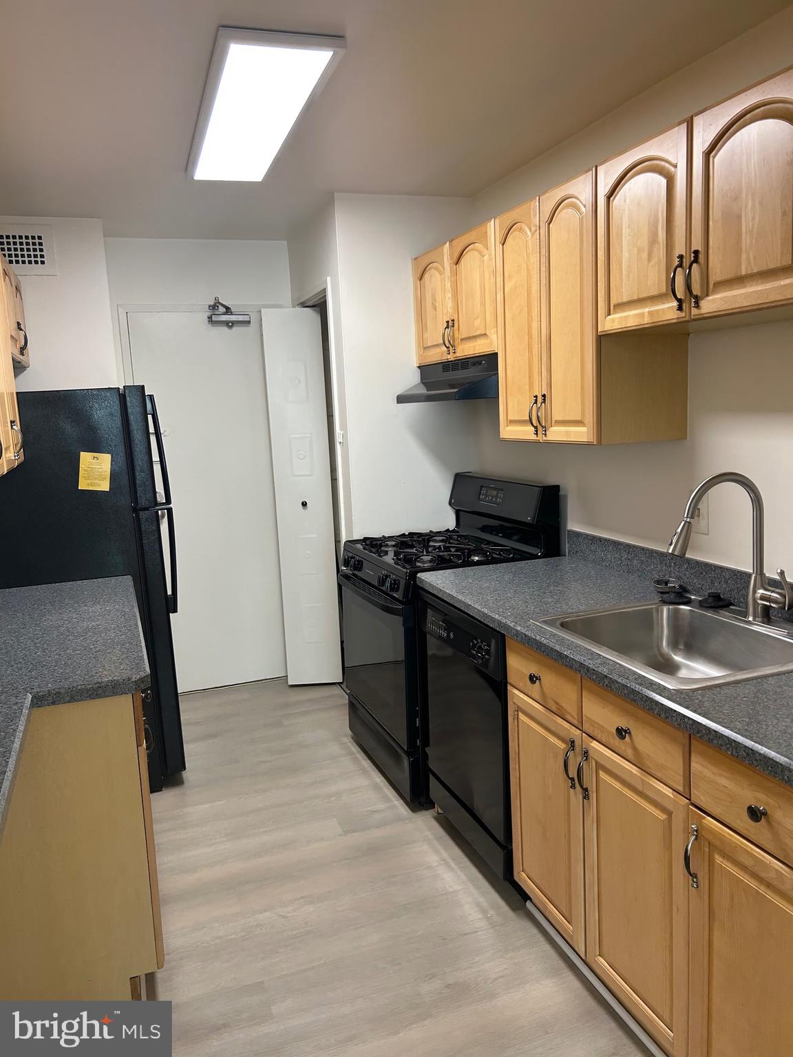 1900 Lyttonsville Road, Unit 214 Silver Spring, MD 20910 - Photo 11 of 21 a kitchen with stainless steel appliances a sink stove and refrigerator