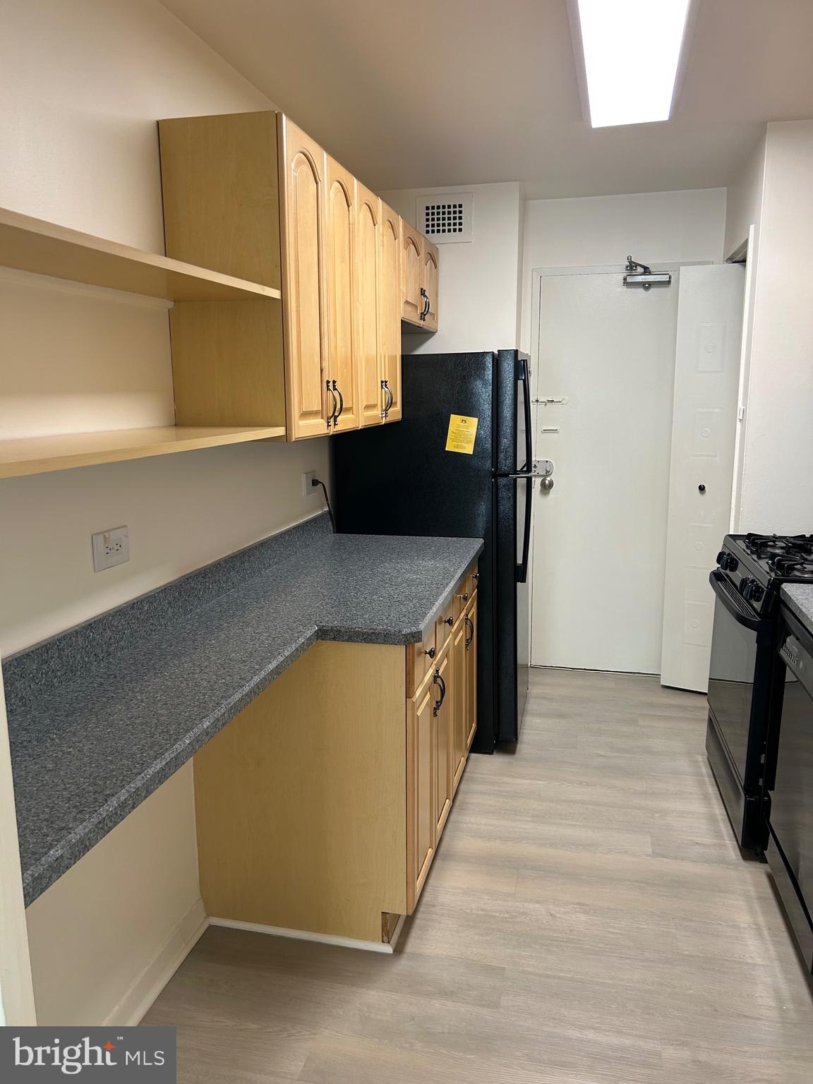 1900 Lyttonsville Road, Unit 214 Silver Spring, MD 20910 - Photo 12 of 21 a kitchen with stainless steel appliances granite countertop a refrigerator and a stove