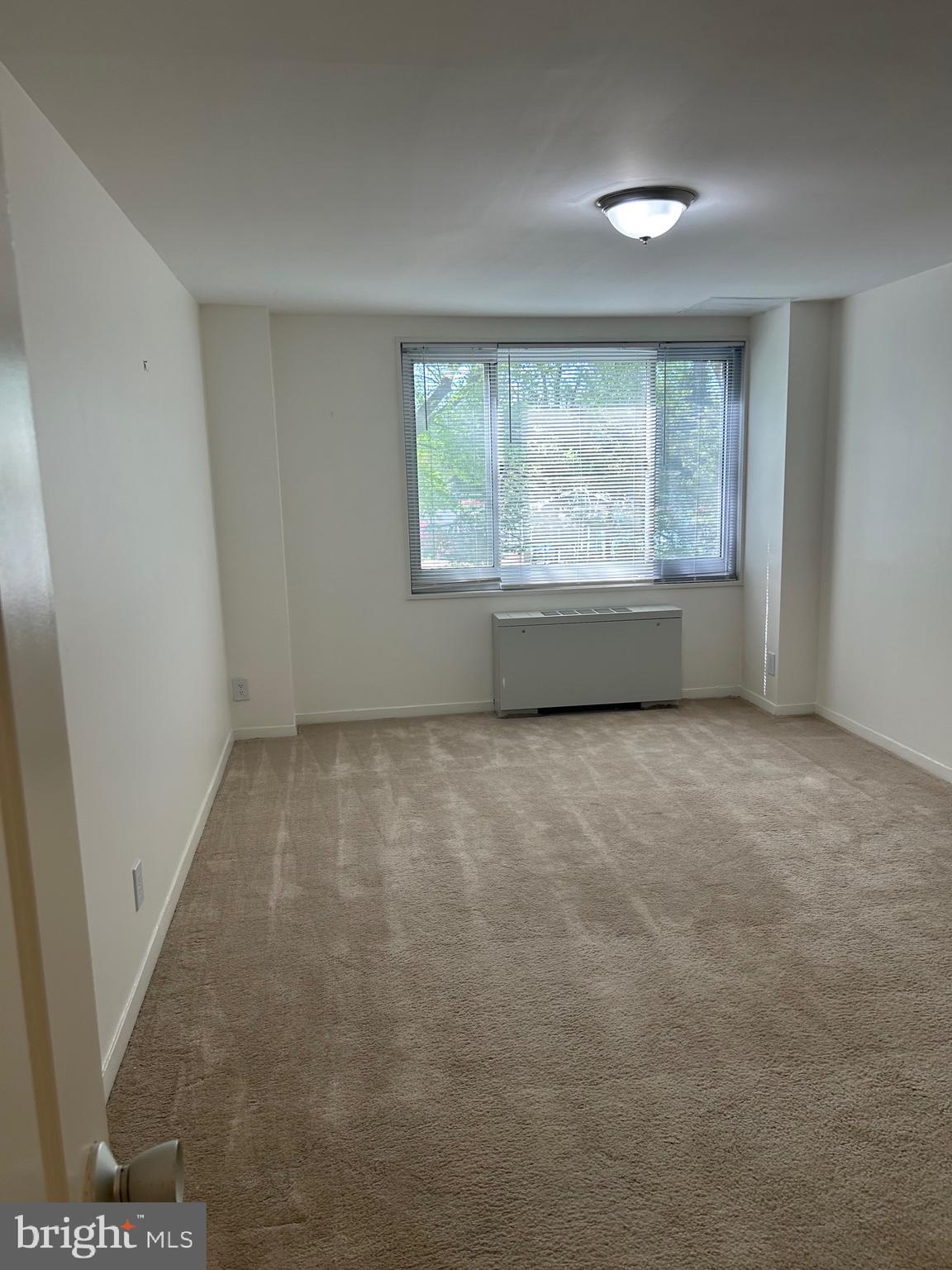 1900 Lyttonsville Road, Unit 214 Silver Spring, MD 20910 - Photo 15 of 21 an empty room with a window