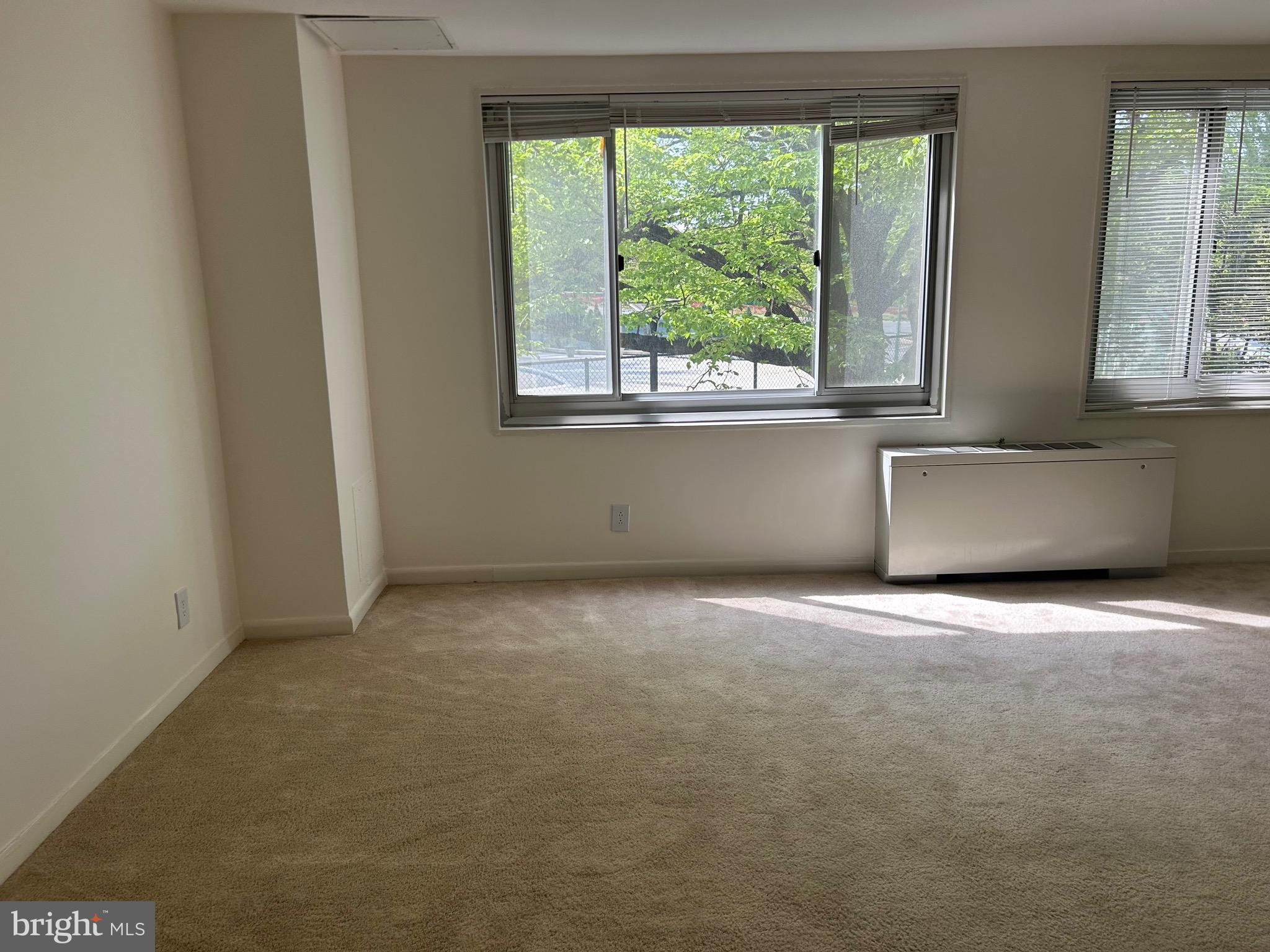 1900 Lyttonsville Road, Unit 214 Silver Spring, MD 20910 - Photo 17 of 21 a view of an empty room with a window
