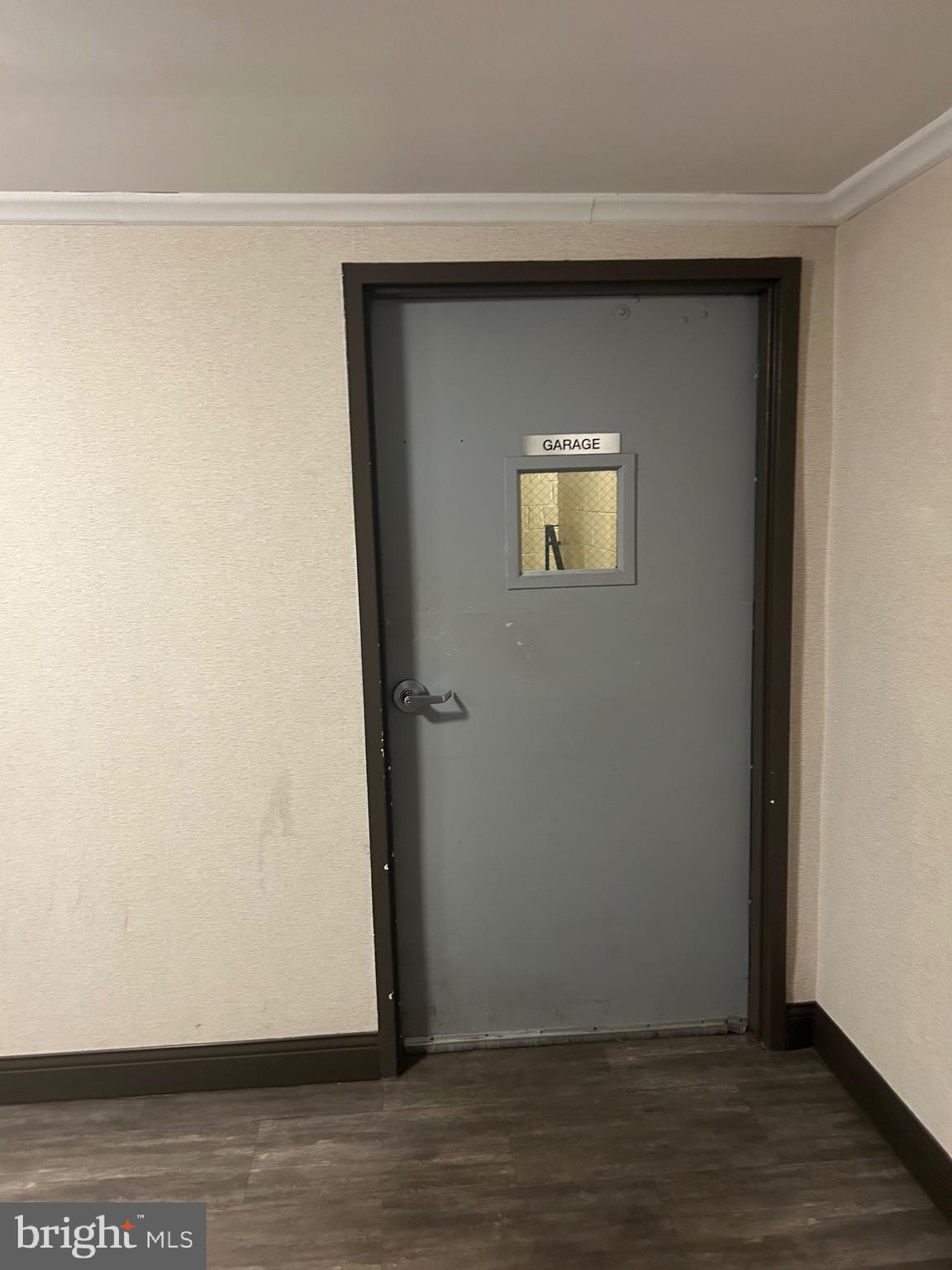 1900 Lyttonsville Road, Unit 214 Silver Spring, MD 20910 - Photo 20 of 21 a view of an empty room with wooden floor and a window