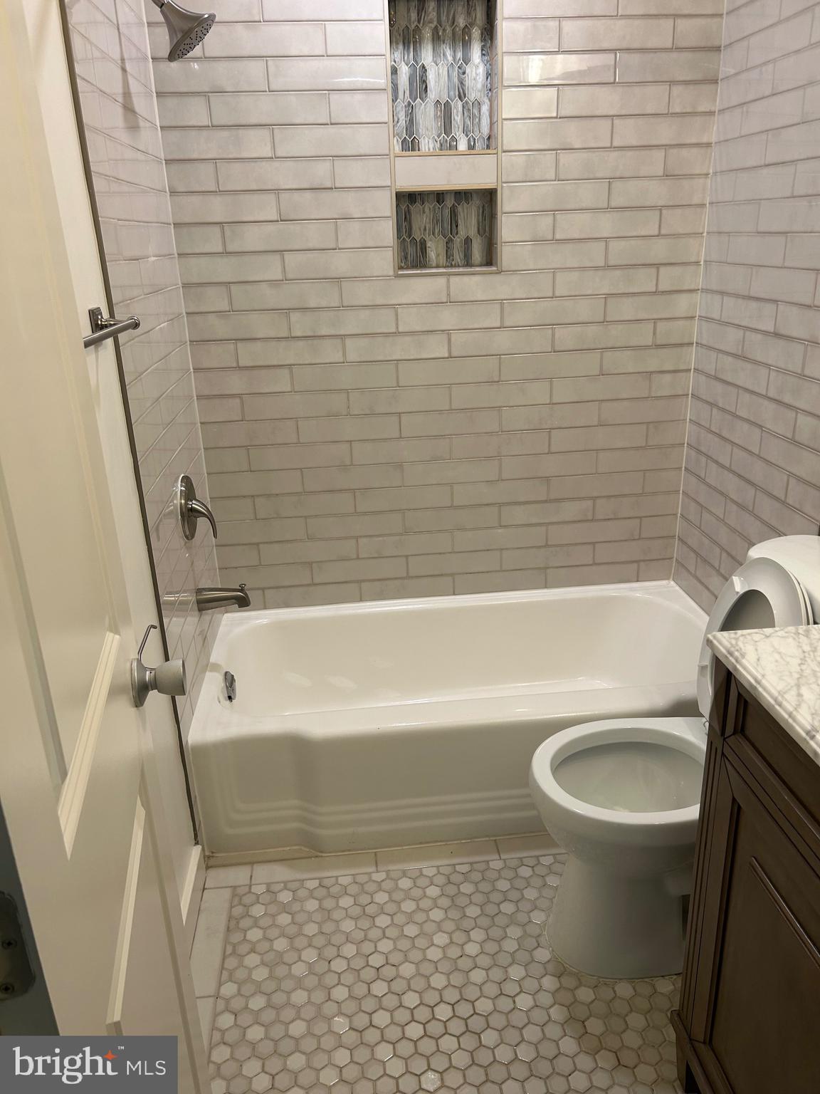 1900 Lyttonsville Road, Unit 214 Silver Spring, MD 20910 - Photo 7 of 21 a bathroom with a toilet a sink and a bathtub