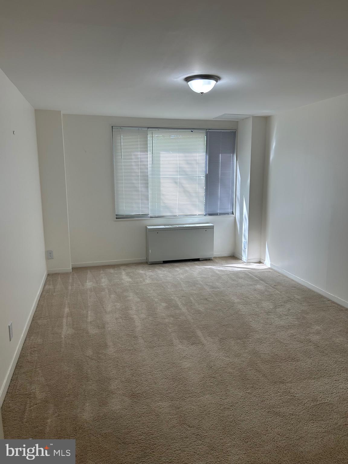 1900 Lyttonsville Road, Unit 214 Silver Spring, MD 20910 - Photo 8 of 21 a view of an empty room with a window
