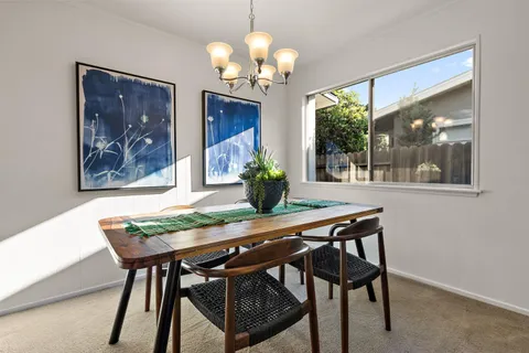 a dining room with furniture and chandelier