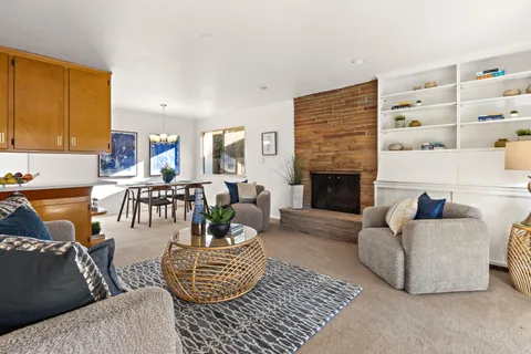 a living room with furniture and fireplace