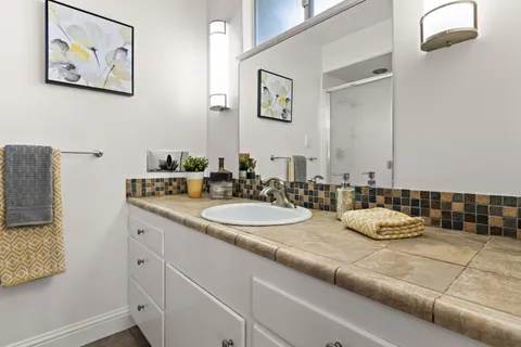 a bathroom with a double vanity sink and a mirror
