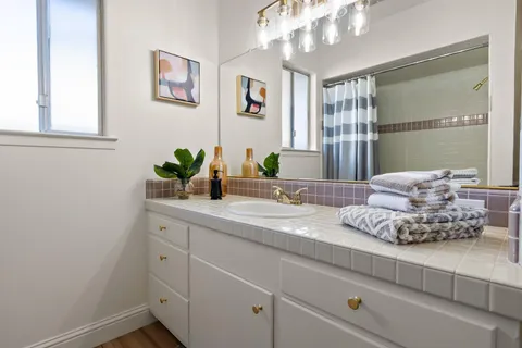 a bathroom with a double vanity sink and a mirror