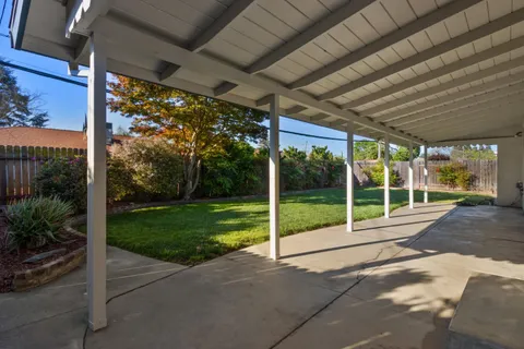 a view of a house with backyard and porch