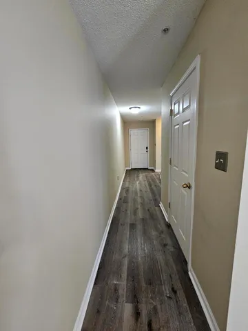a view of a hallway with wooden floor