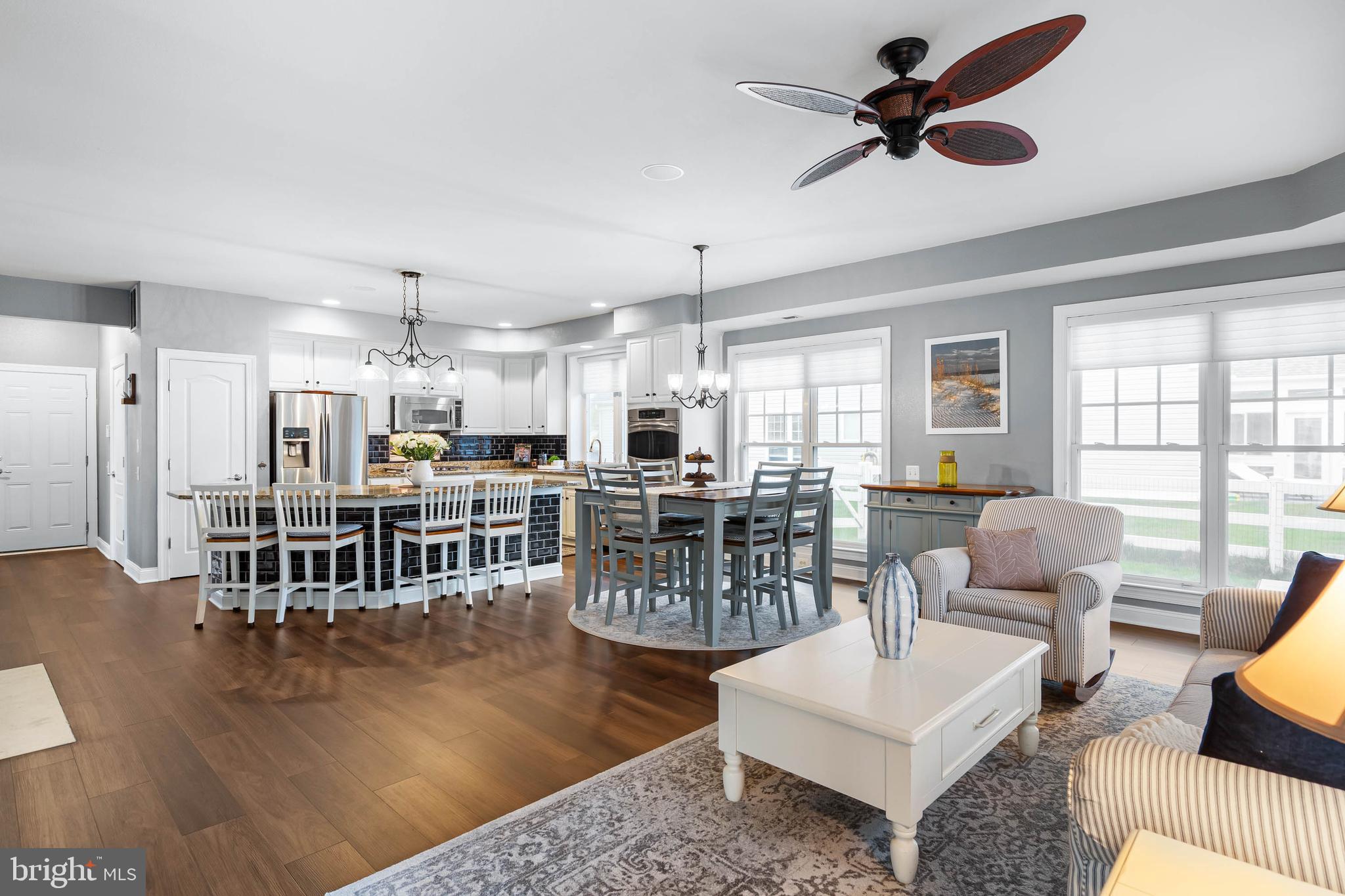 20718 Annondell Drive Lewes, DE 19958 - Photo 16 of 46 a living room with lots of furniture wooden floor and a chandelier