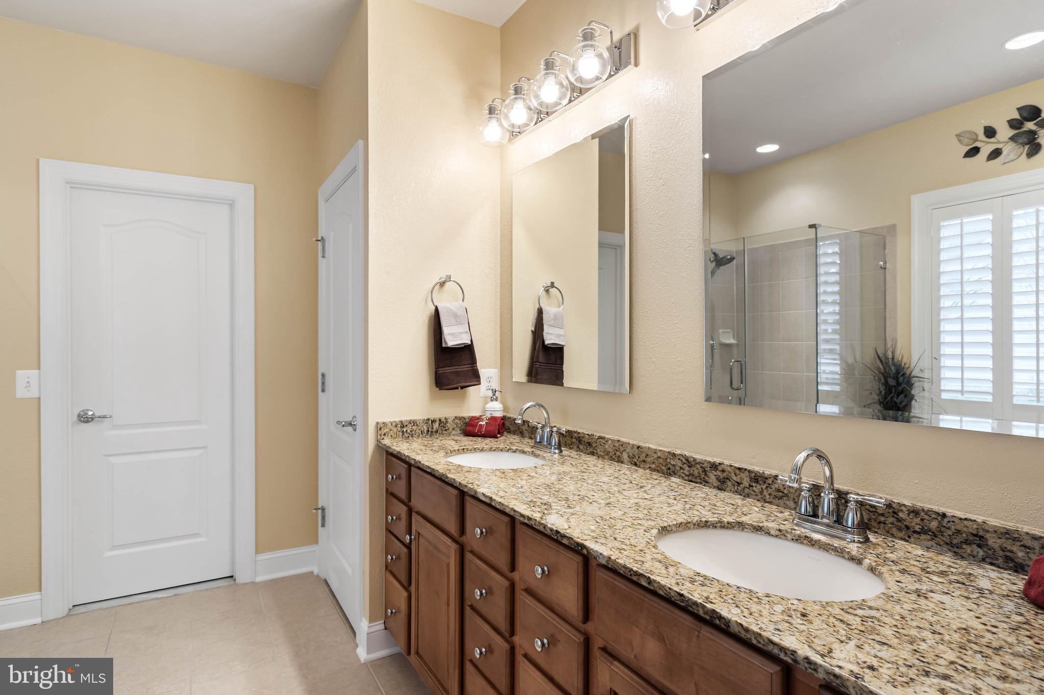 20718 Annondell Drive Lewes, DE 19958 - Photo 29 of 46 a bathroom with a granite countertop double vanity sink and a mirror