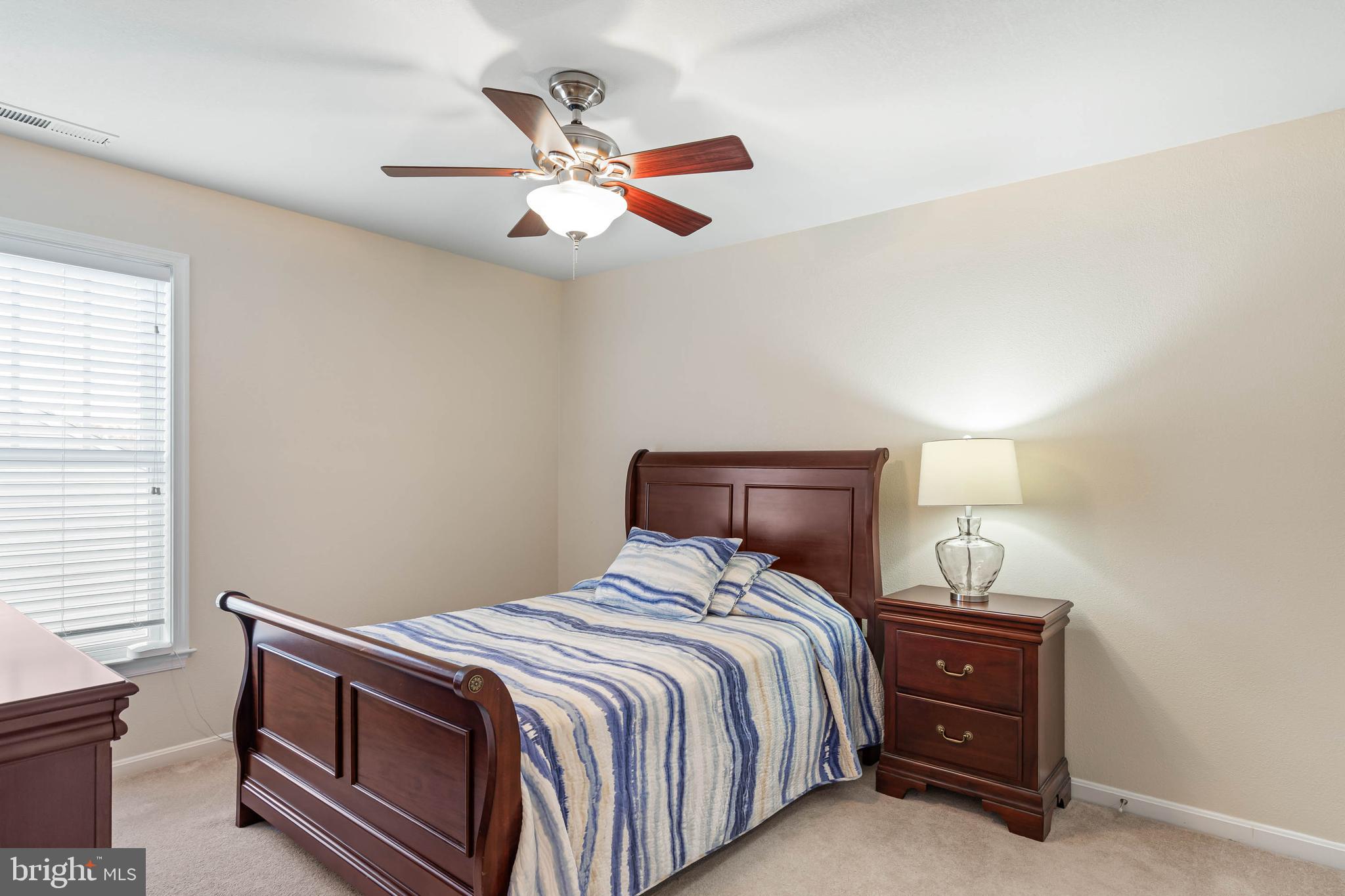 20718 Annondell Drive Lewes, DE 19958 - Photo 36 of 46 a bedroom with a bed and a chandelier