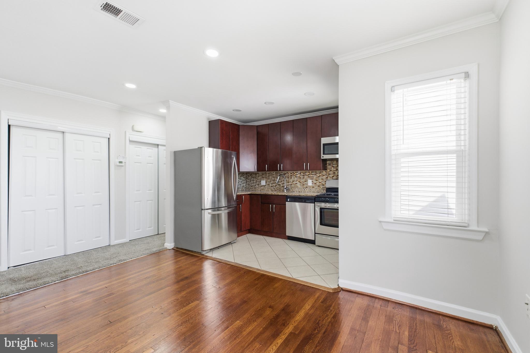 2712 6th Street Northeast Washington, DC 20017 - Photo 5 of 24 a kitchen with stainless steel appliances kitchen island granite countertop a refrigerator and a sink