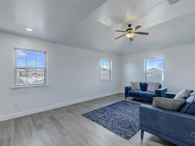 a living room with furniture and a rug