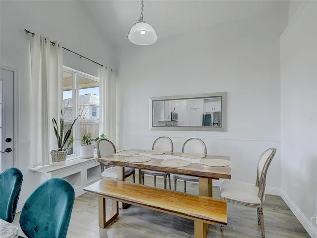 a kitchen with white cabinets stainless steel appliances and kitchen island