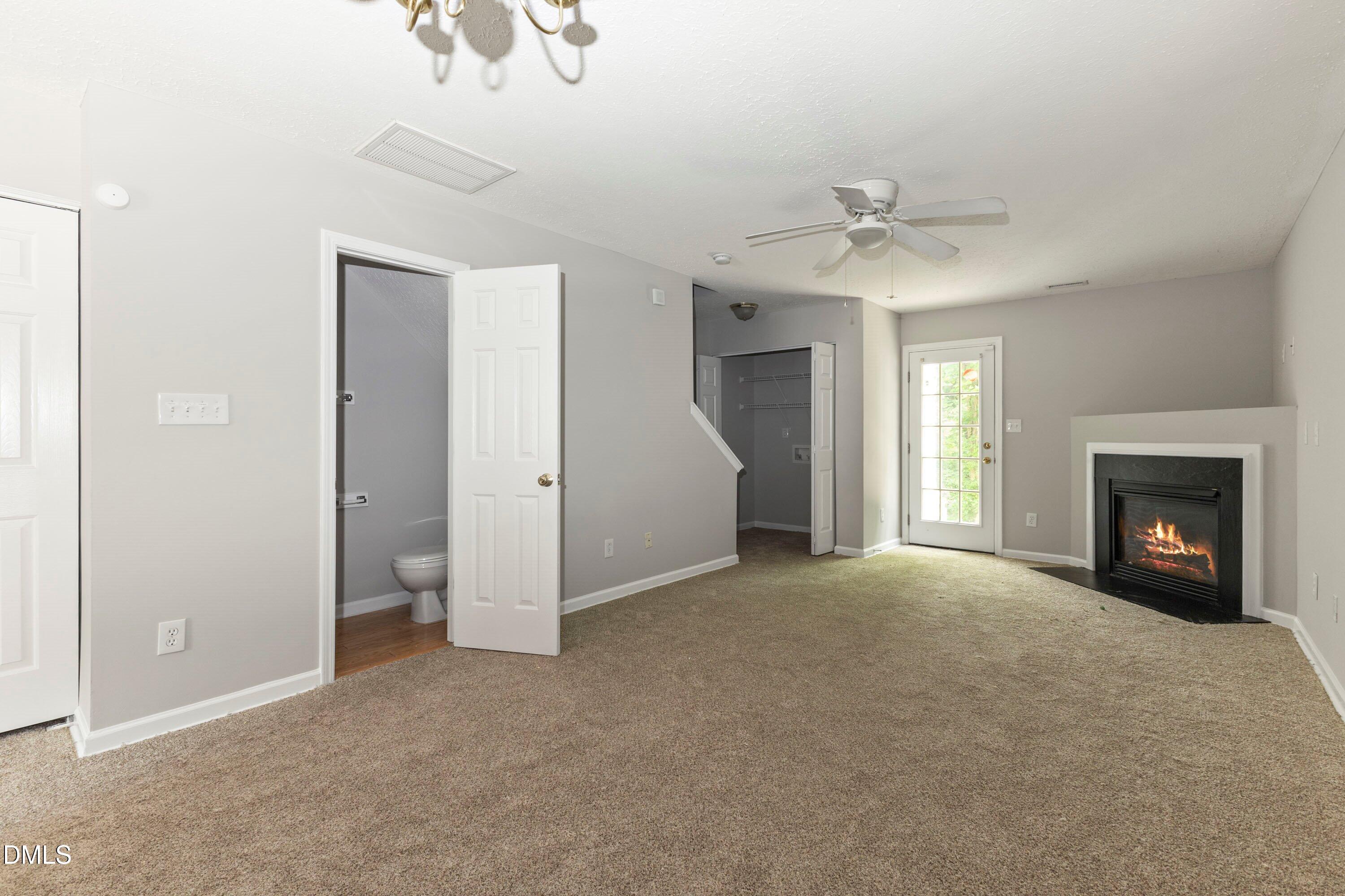 3358 Tarleton West Durham, NC 27713 - Photo 10 of 23 a view of a livingroom with a fireplace and chandelier fan