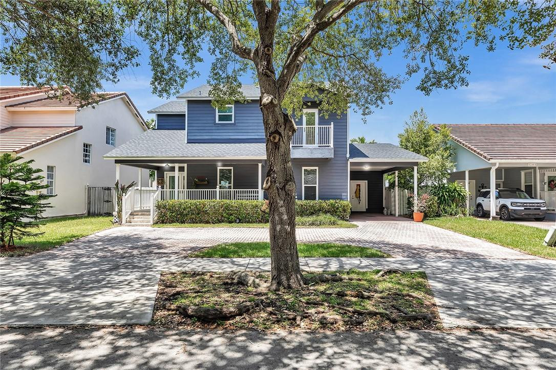 15971 Southwest 96th Terrace Miami, FL 33196 - Photo 1 of 79 a front view of a house with a yard and trees