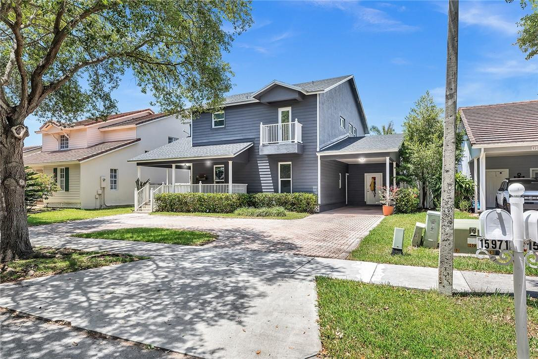 15971 Southwest 96th Terrace Miami, FL 33196 - Photo 3 of 79 a front view of a house with a yard