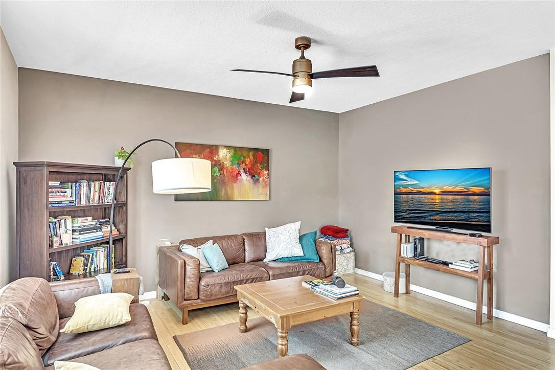 15971 Southwest 96th Terrace Miami, FL 33196 - Photo 32 of 79 a living room with furniture and a flat screen tv