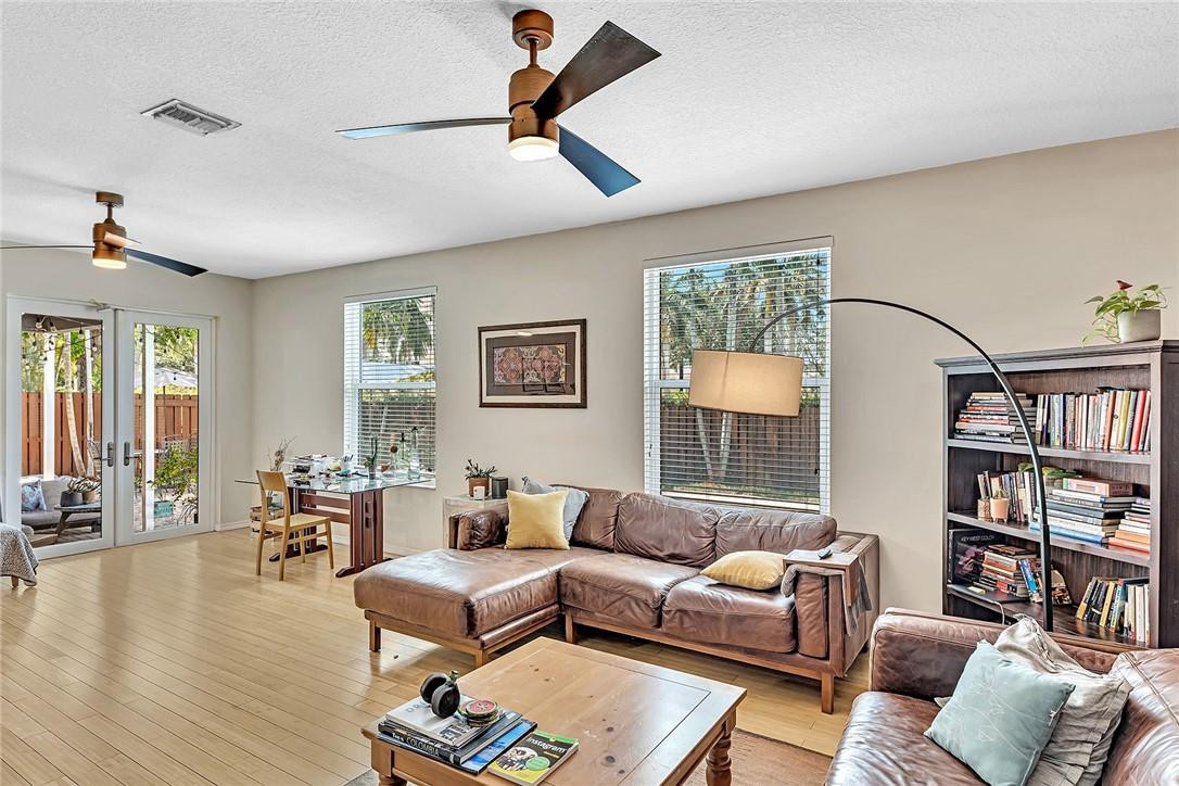 15971 Southwest 96th Terrace Miami, FL 33196 - Photo 34 of 79 a living room with furniture and a book shelf