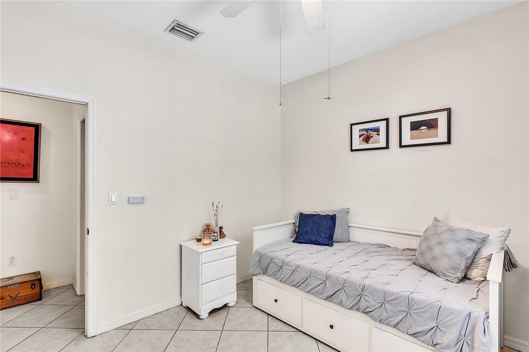 15971 Southwest 96th Terrace Miami, FL 33196 - Photo 40 of 79 a bedroom with a bed and a table